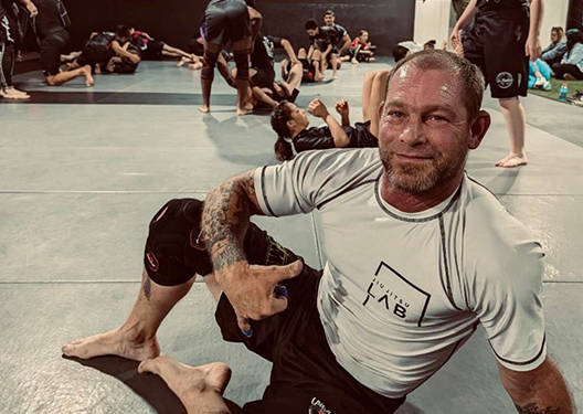 Adult looking happy after a Jiu Jitsu Lesson